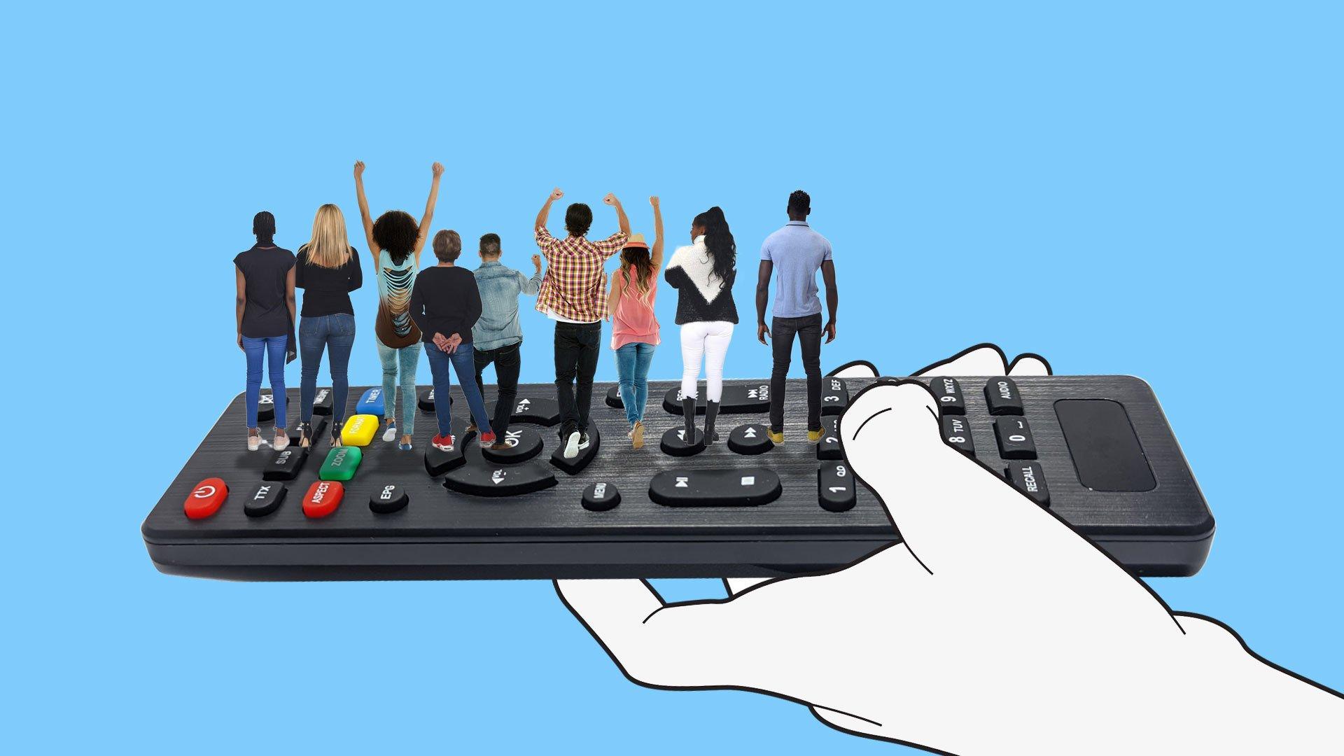 A group of people stand back facing on a remote that's held up by a hand against a blue background