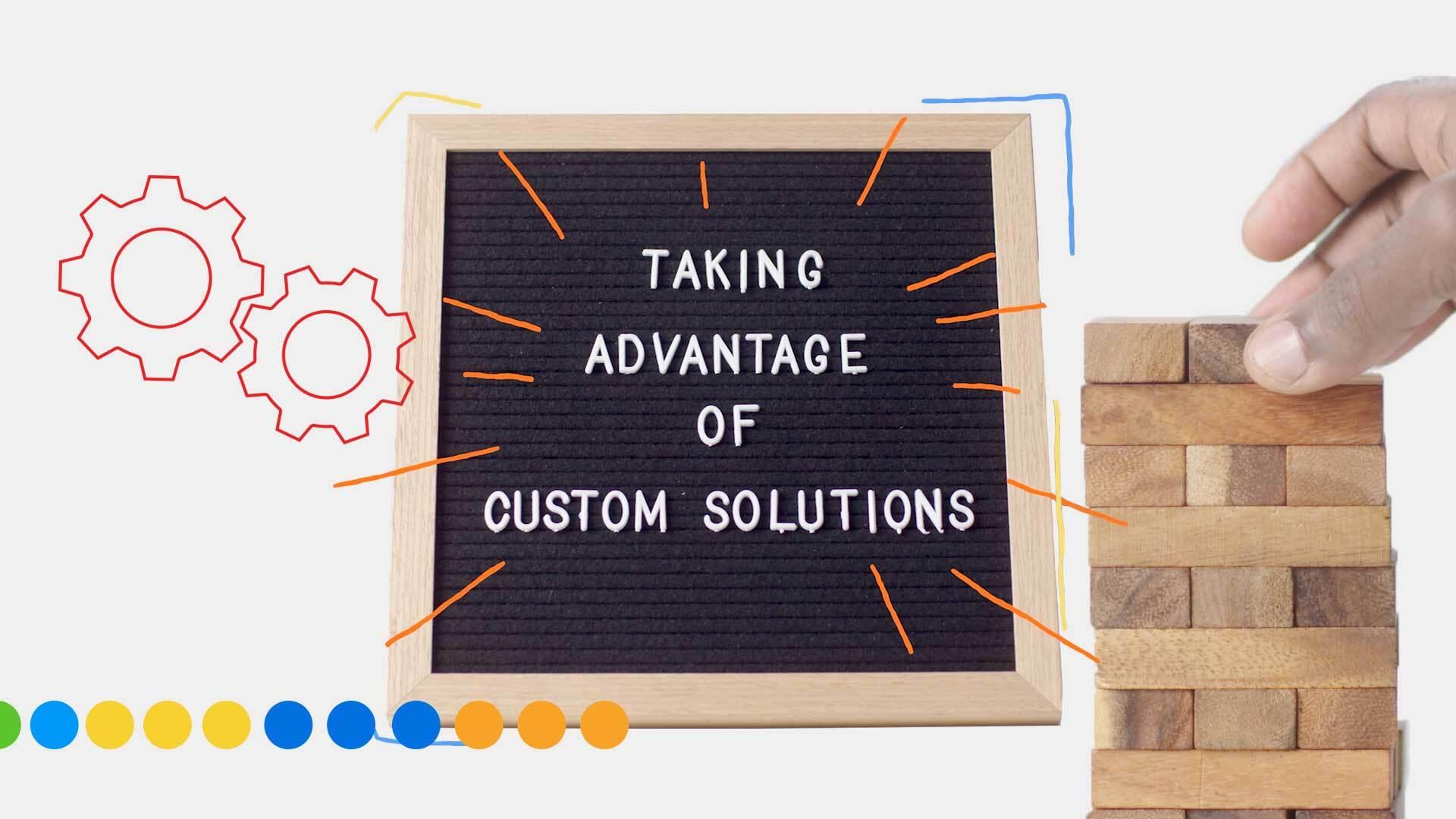 A letter board reads "Taking advantage of custom solutions" while a hand builds a tower on the right hand side.