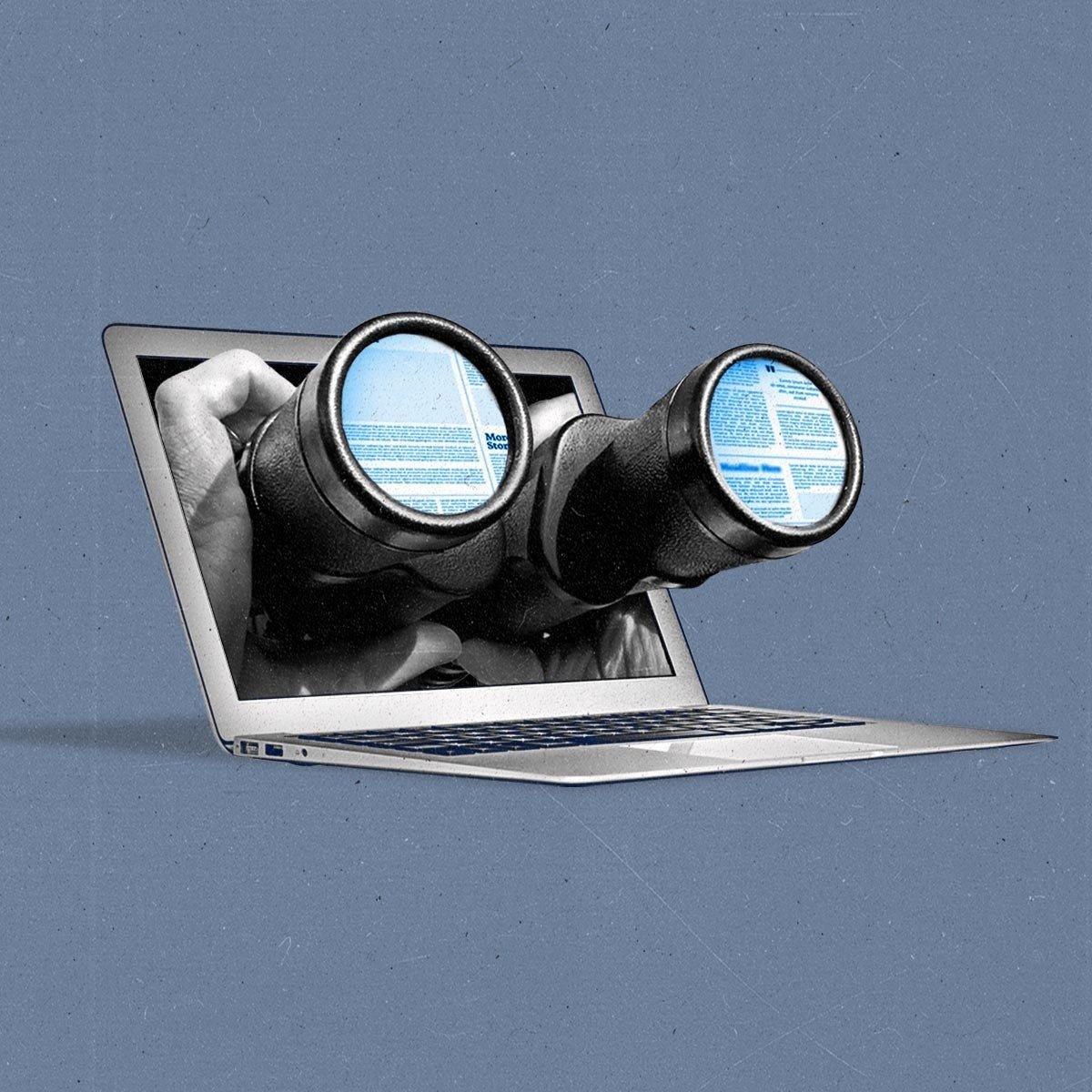 A pair of hands holds binoculars through a laptop, with the reflection of news websites in the lenses.
